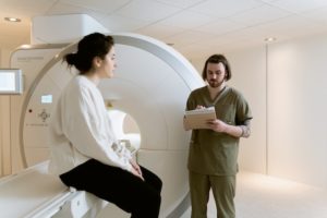 Tech preparing patient for MRI after taking travel radiology tech jobs at the facility