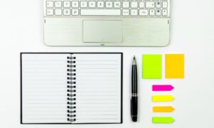 computer, notebook, post-it notes to get organized and work with medical staffing agency