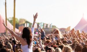 woman in allied health jobs enjoying music festival crowd